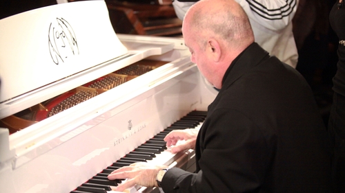 Musician Billy Joel playing a Steinway piano