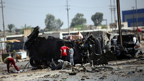 The scene of a car bomb in Baghdad's eastern neighbourhood of Baladiyat is inspected