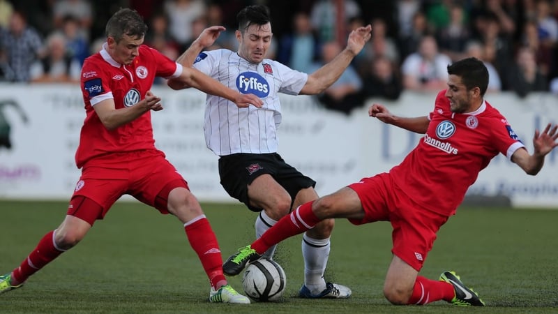 Richie Towell is challenged by Jeff Henderson and Seamus Conneely