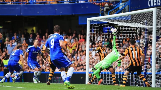 Goalkeeper Allan McGregor of Hull City makes a one-handed save on the line from Branislav Ivanovic of Chelsea