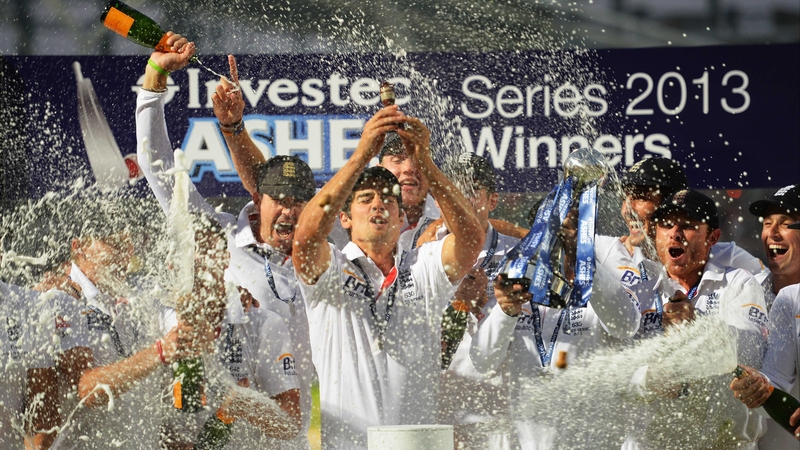 Alastair Cook lifts the urn as England celebrate