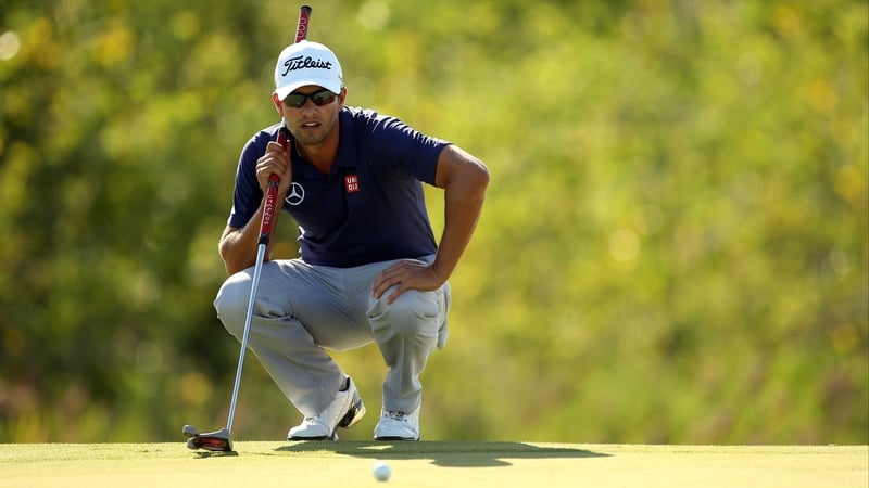 Adam Scott lines up a putt on the 17th