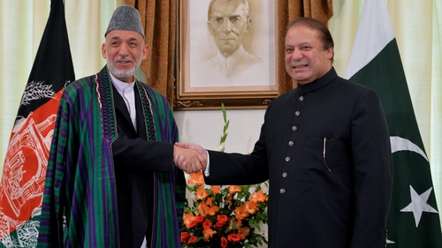 Afghan President Hamid Karzai and Pakistani Prime Minister Nawaz Sharif shake hands for photographers in Islamabad