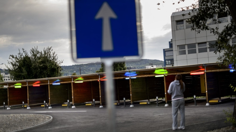 A prostitute faces 'sex boxes' at the opening day of Switzerland's first sex drive-in