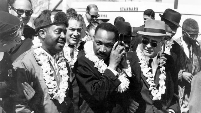 Martin Luther King listens to the radio while leading the Alabama Civil Rights march