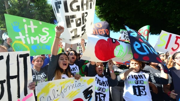Fast food workers and supporters take part in a strike outside a McDonald's outlet in Los Angeles