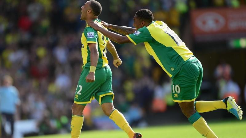 Nathan Redmond (l) celebrates his goal for the Canaries