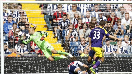 Swansea City's Ben Davies (R) scores past West Brom goalkeeper Boaz Myhill