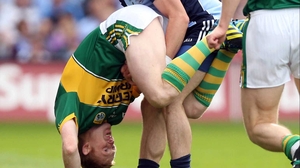 Kerry's Colm Cooper gets a lift off Ger Brennan