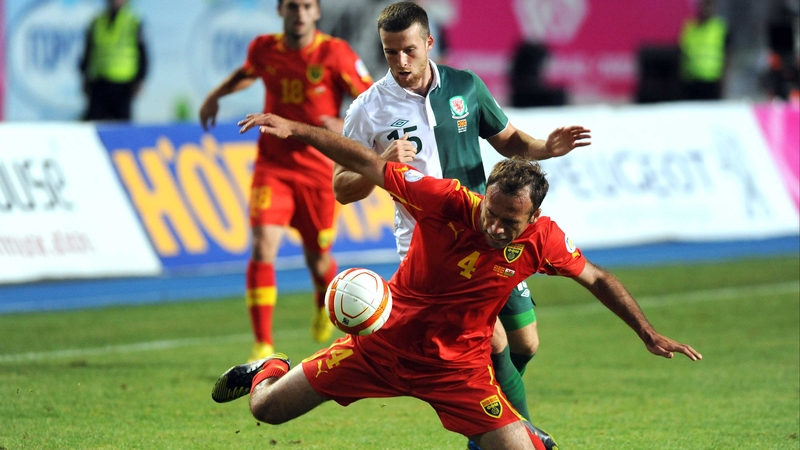 Macedonia's Nikolche Noveski (Front) vies for the ball with Wales's Adam Matthews