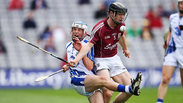 Michael Harney of Waterford takes a heavy tackle from Galway's Sean Linnane.