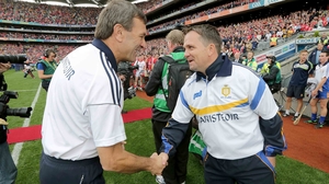 The rival managers exchange a handshake prior to battle