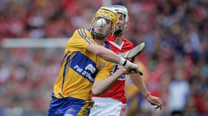 Clare's Colm Galvin clears the ball despite the attention of Luke O'Farrell