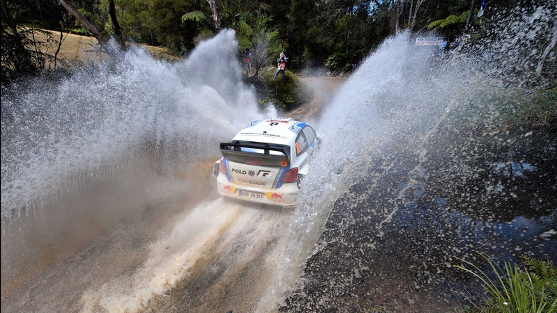 Sebastian Ogier passes through a water crossing