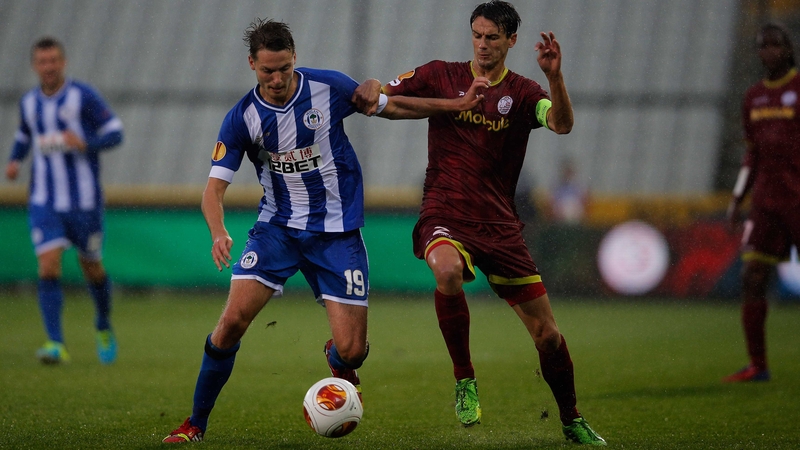 Wigan's Nick Powell and Davy de Fauw of Zulte Waregem battle for possession in in Bruges