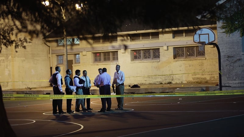 Police investigate the scene in Cornell Square Park on the southside of Chicago