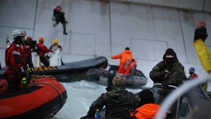 Two Greenpeace activists scaled the side of the platform and were arrested (Denis Sinyakov/Greenpeace)