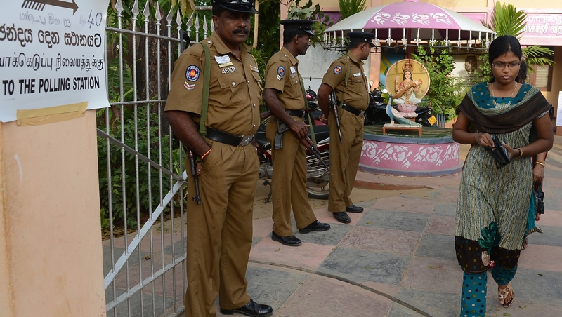 A Sri Lankan woman leaves a polling station after voting in Jaffna earlier today