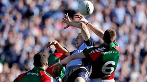 Eoghan O'Gara and Donal Vaughan battle for possession