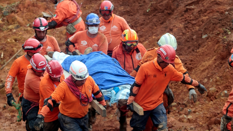 Mexican rescue team 'Topos' (Moles) personnel dig out the body a the victim of a landslide in La Pintada in Guerrero state