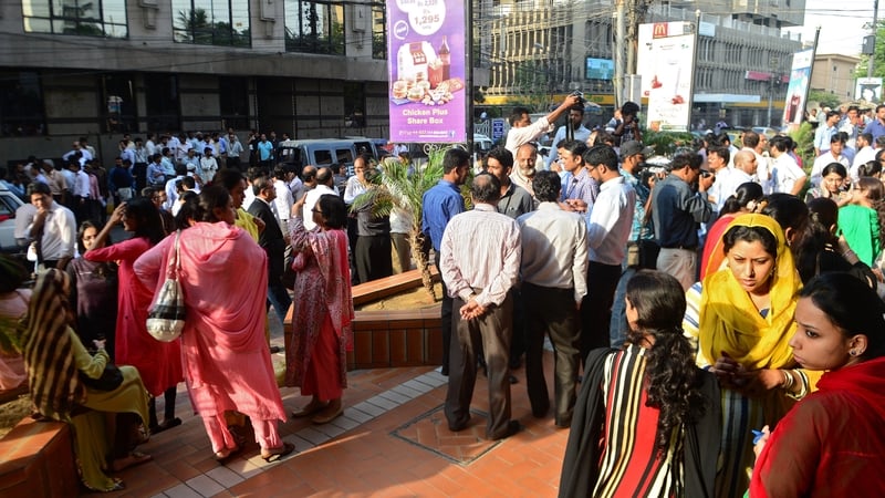 Workers left their office buildings after feeling the earthquake in Karachi