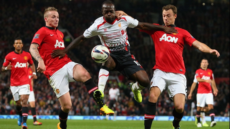 Victor Moses of Liverpool is challenged by Alex Buttner and Jonny Evans