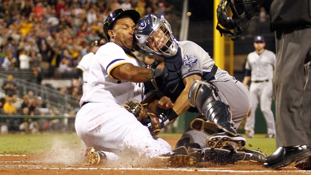 Nick Hundley of the San Diego Padres tags out Marlon Byrd of the Pittsburgh Pirates at PNC Park in Pittsburgh, Pennsylvania.