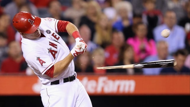 Mike Trout of the Los Angeles Angels of Anaheim hits a broken bat single against the Seattle Mariners at Angel Stadium of Anaheim, California.