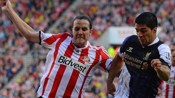 Captain John O'Shea tussles with Luis Suarez during Sunday's home defeat to Liverpool
