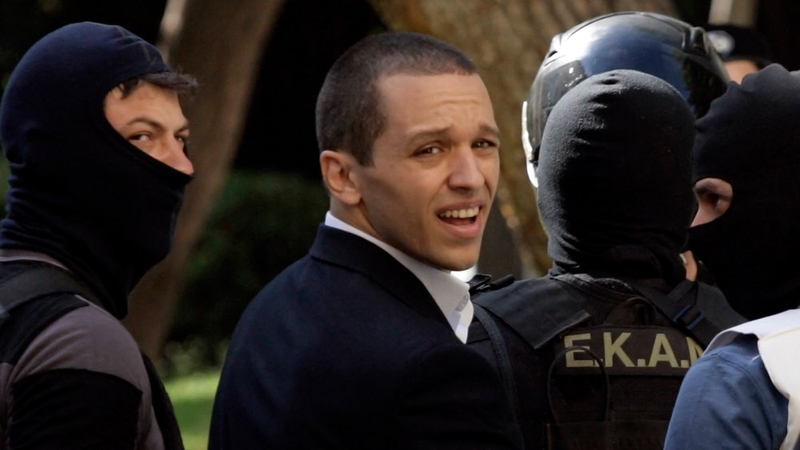 Golden Dawn spokesman Ilias Kasidiaris is escorted by anti-terror police into court