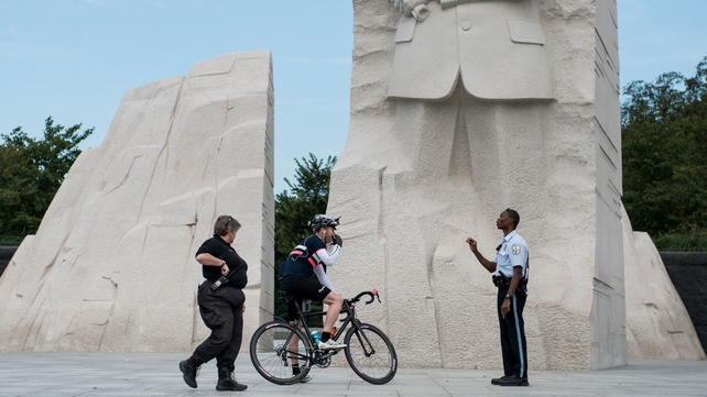 US Park Police Officers speak to a cyclist while closing the Martin Luther King Jr Memorial in Washington