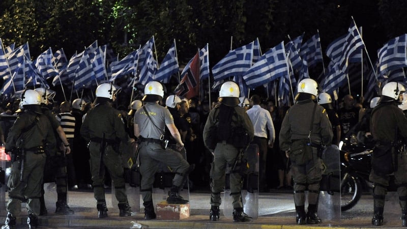 Police monitor a demonstration by Golden Dawn supporters in Athens