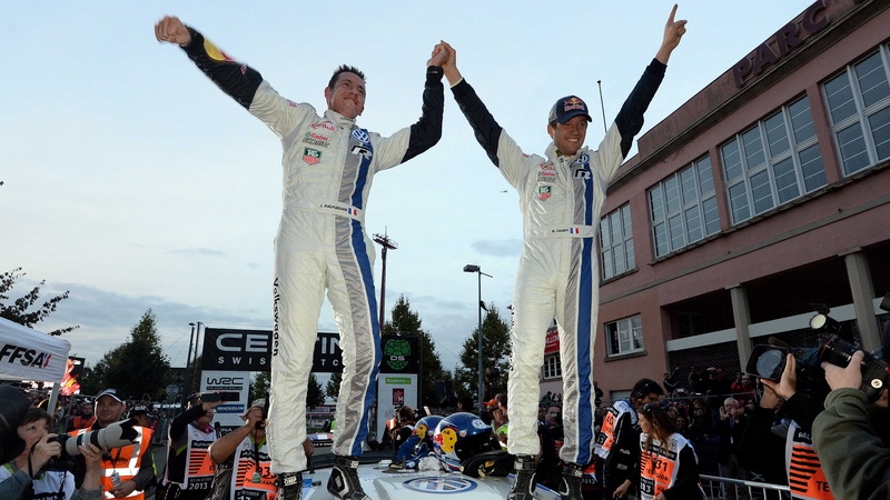 France's Sebastien Ogier (R) and co-driver Julien Ingrassia celebrate their world champion title