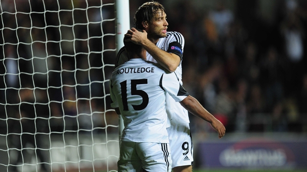 Goalscorer Wayne Routledge receives the congratulations from Michu