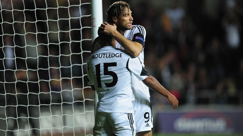 Goalscorer Wayne Routledge receives the congratulations from Michu