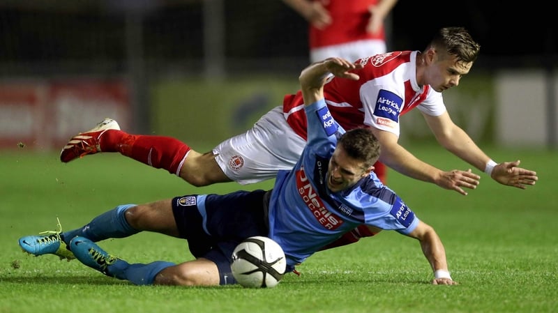 Robbie Creevy of UCD tangles with Greg Bolger of St Pat's