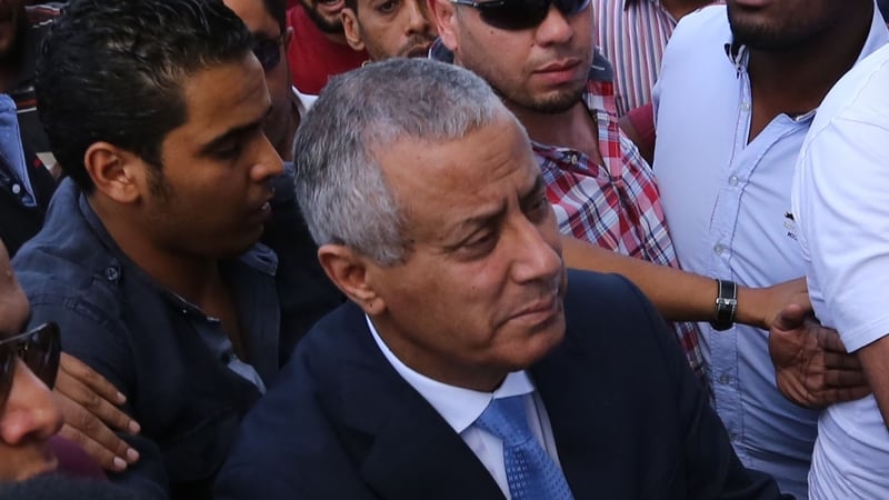Libyan Prime Minister Ali Zeidan (C) arrives at the government headquarters in Tripoli after his release