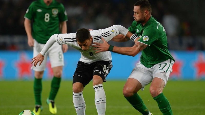 Damien Delaney tries to get the better of German play-maker Mesut Ozil