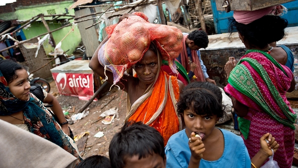 A woman heads for home after Cyclone Phailin sparked one of India's largest-ever evacuations