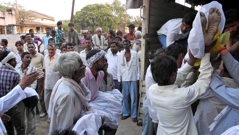 Bodies of Hindu devotees are loaded onto a truck following a stampede outside the Ratangarh Temple in Datia district