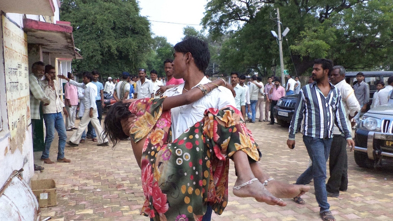 An injured woman is carried from the scene