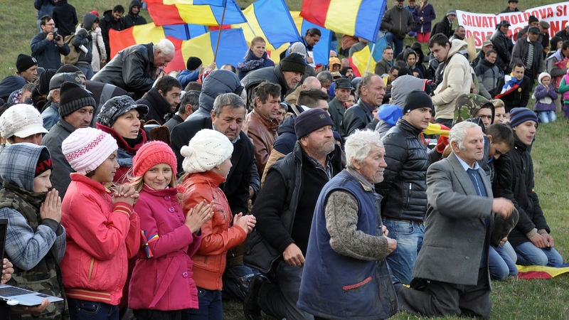 Protesters kneel to pray during an anti-fracking protest in Silistea village in Romania