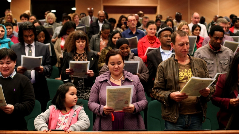 New Irish citizens taking place in a citizenship ceremony in October 2013