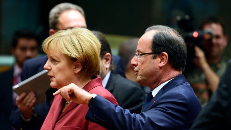 French President Francois Hollande talks with German Chancellor Angela Merkel
