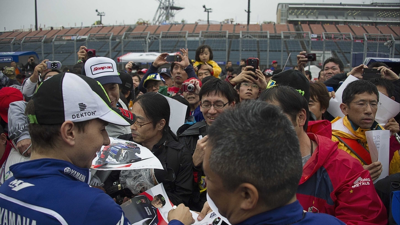 Jorge Lorenzo signs autographs during the pit walk in Japan