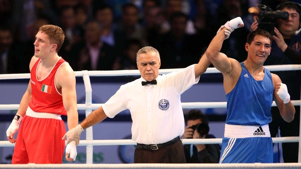 Zanibek Alimkhanuly's hand is raised in victory