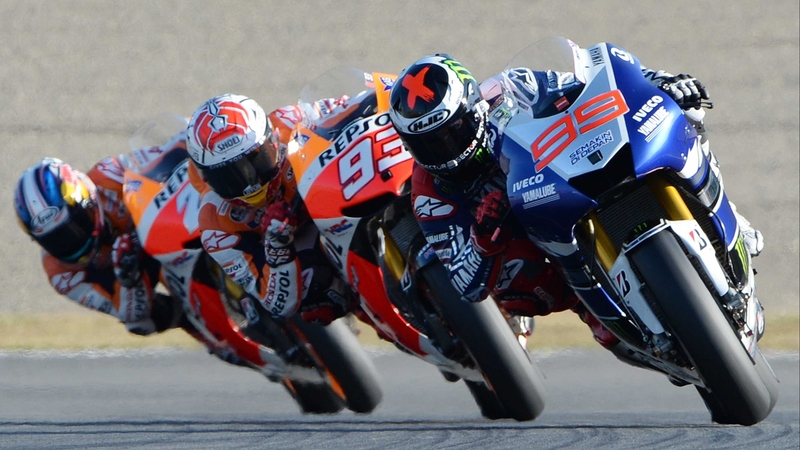 Yamaha's Jorge Lorenzo (R) leads Marc Marquez and Dani Pedrosa on his way to victory