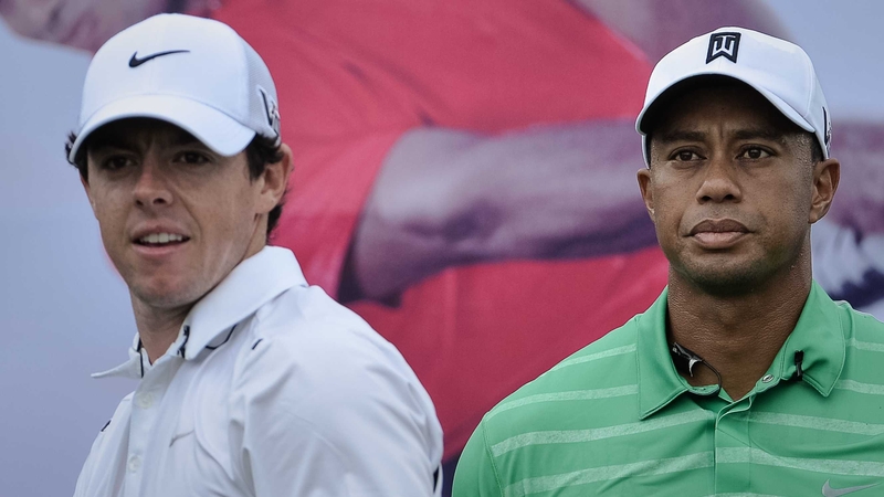 Rory McIlroy and Tiger Woods look on during their one-on-one golf match-up