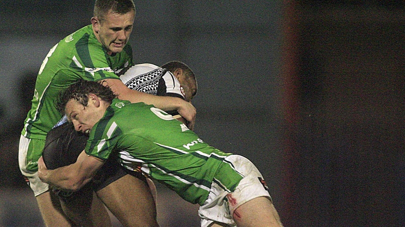 Fiji's Kevin Naiqama is tackled by Ben Currie and Rory Kostjayn