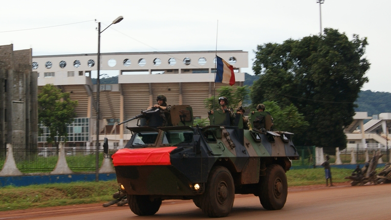 French soldiers patrol aboard a military vehicle on a street in Bangui